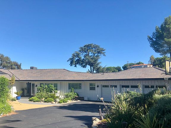 Spacious driveway and three car garage.