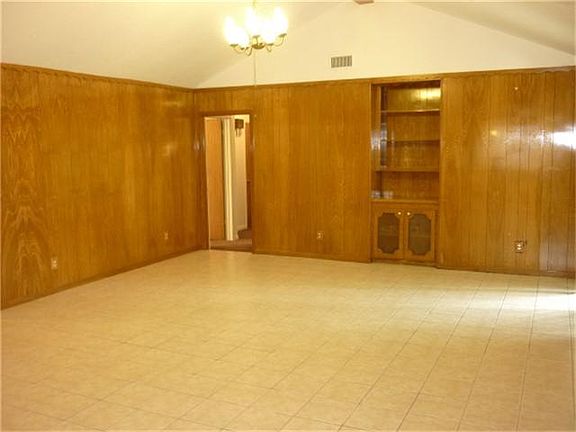 Spacious family room with high ceiling & built-in display & storage cabinet