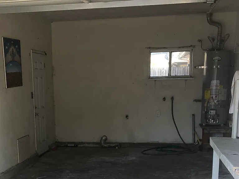 Large garage with garage door opener, with washer/dryer hookups.