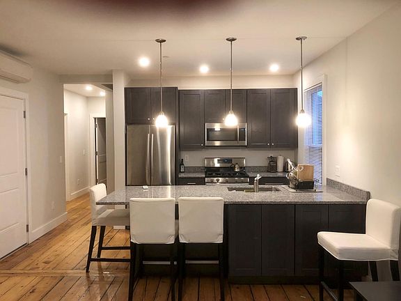 New kitchen with high-end stainless appliances (gas stove), stone counter, undermount sink, soft-close cabinetry