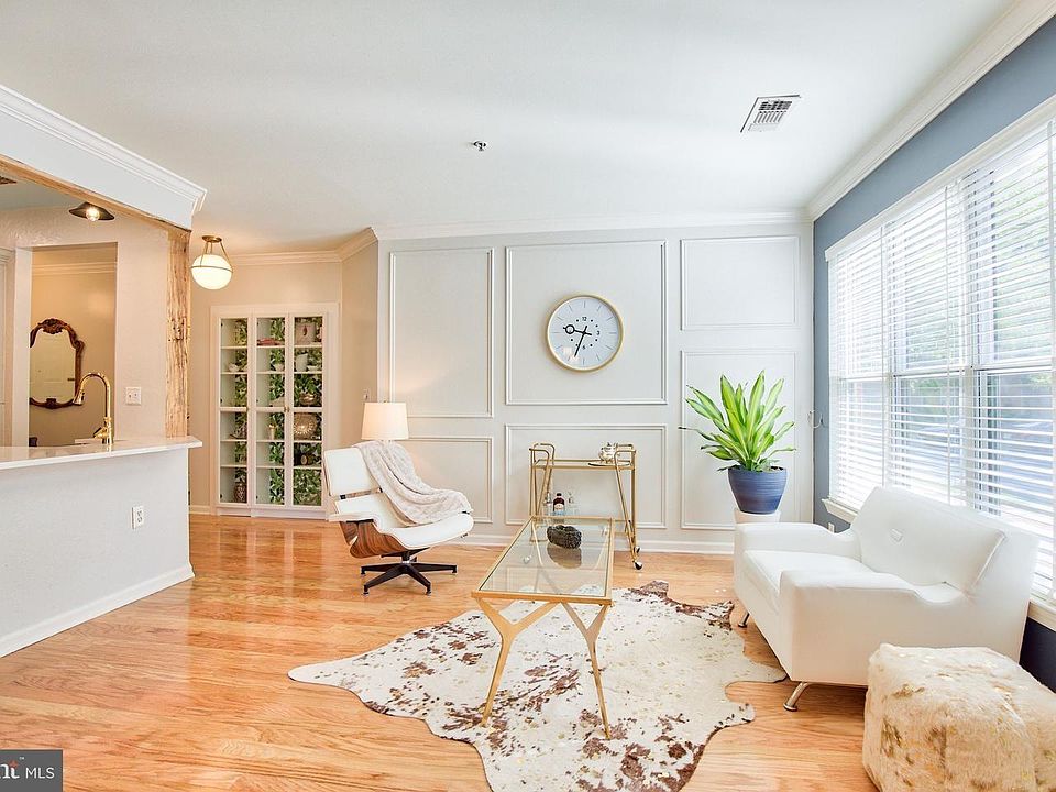 No detail was spared in this homey condo. Large Living Room with custom trim and hardwood throughout. Benjamin Moore paint throughout. Upgraded, 2" wood slat window treatments throughout.
