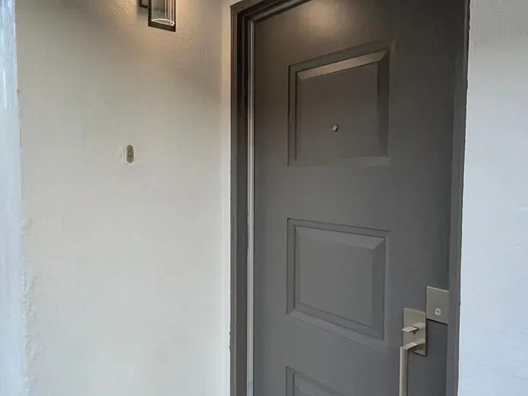 Front door entry behind new private gate entrance.