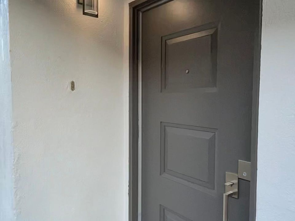 Front door entry behind new private gate entrance.