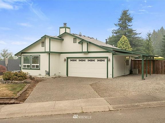 Two car garage with an extra carport