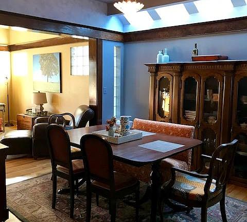 dining room has hardwood floors and trim, antique lighting and skylights