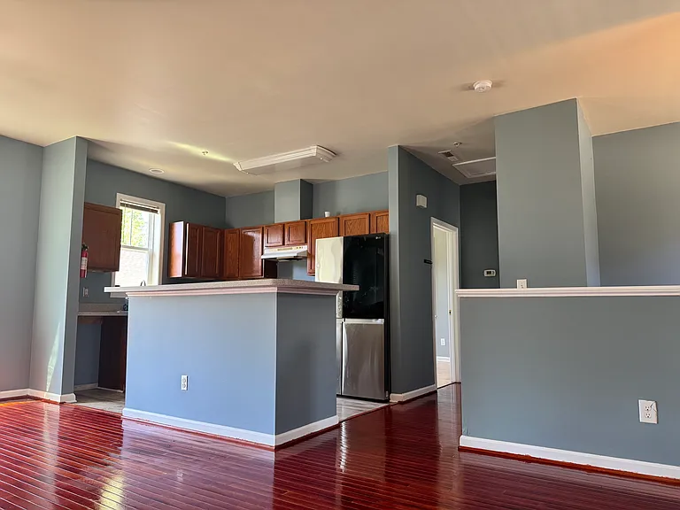 The kitchen island is the heart of this space. It's great for prepping meals, grabbing a quick breakfast, or just hanging out. Lots of counter space and room to move around.