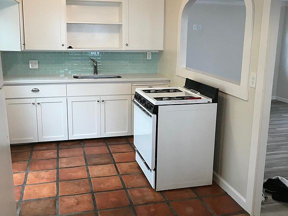Full Kitchen with Fridge and gas stove.