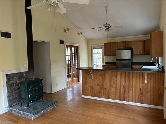 Living room looking to kitchen and French doors into dining room or office.
