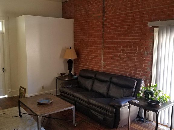 Living room. Bedroom is behind door. Operable transoms above doors.