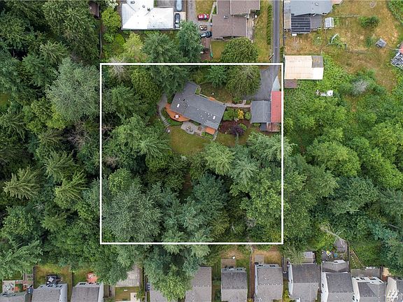 This aerial photos shows you just how large this parcel is. The home is nestled among the trees and feels a million miles away, but is only blocks away from miles of King County trails along Soos Creek, this neighborhood is ideally located with easy access to freeways, dining, retail and business hubs. (Lot lines are approximate and not for legal use)