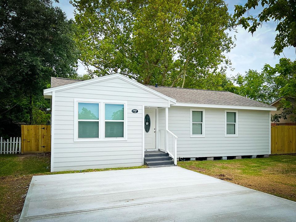 Front view featuring new 5 car concrete driveway, 30 year roof, hardi-plank siding, double pane windows, and new front door.