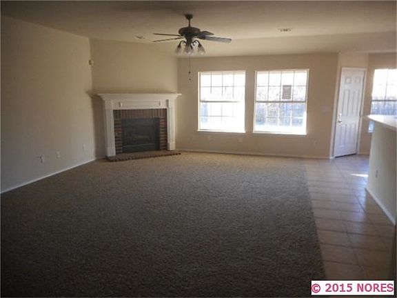 Large living room with fireplace and natural lighting
