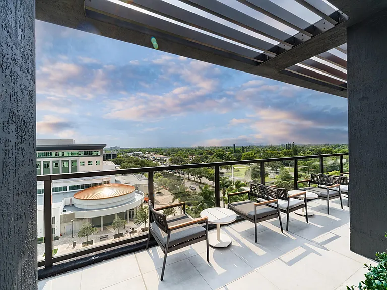 Covered rooftop overlook with lounge seating and sweeping Coral Springs views, offering a relaxed perch for morning coffee or evening conversations.