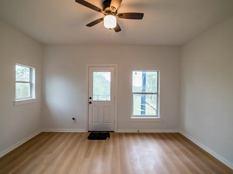Downstairs bedroom leading to back porch