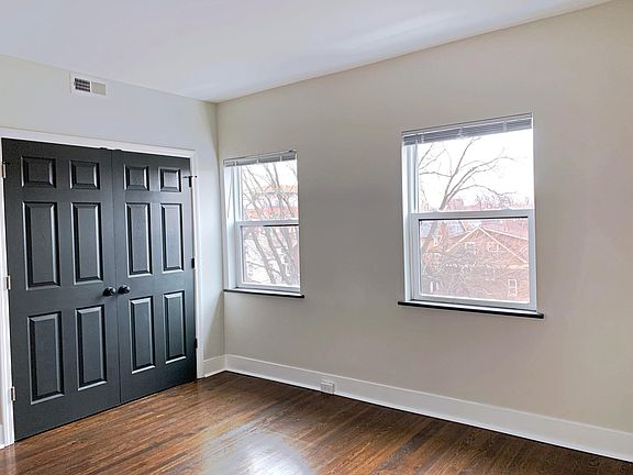 Bedroom two with newly refinished hardwood floors, new windows and ample closet space.