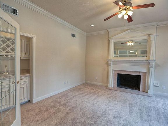 Elegant study features fireplace and wetbar.