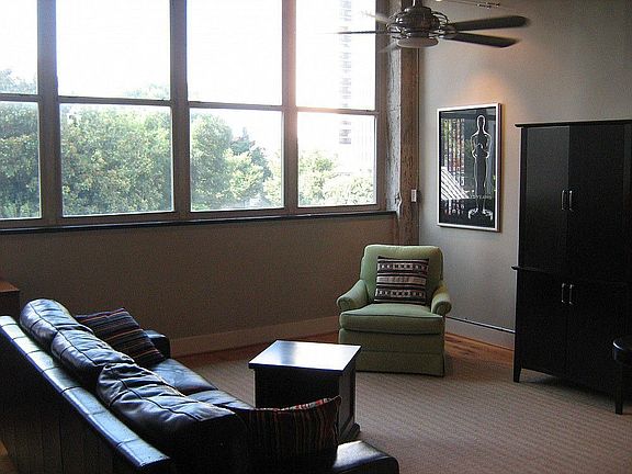 Oversized living room with wall of windows and motorized blinds