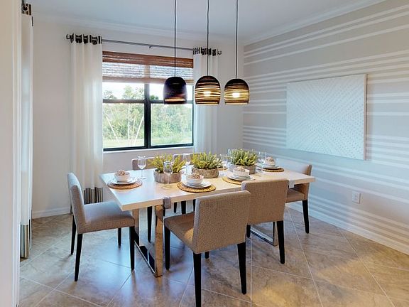 Flowing from the kitchen, this dining room offers a cozy space to eat with family while overlooking