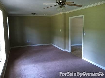 Living Room, view Dining Entrance
						:
						khaki color walls and tan carpet (ad color incorrect)
