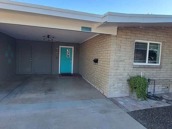 Front of home with carport.