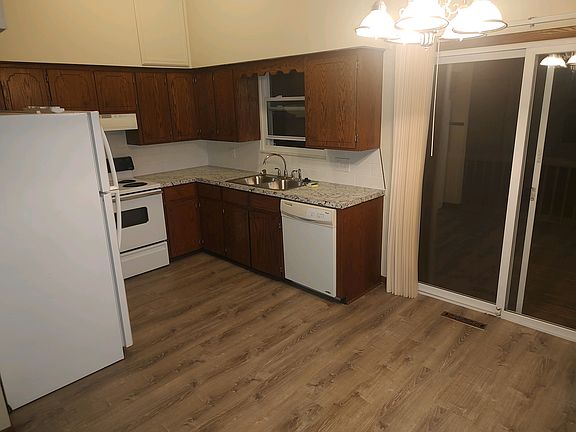 Kitchen with all appliances and a sliding glass door that walks out to your deck. New LVT flooring, new countertops, kitchen sink and faucet