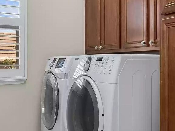 Side by side on pedestal front loading Samsung washer and dryer