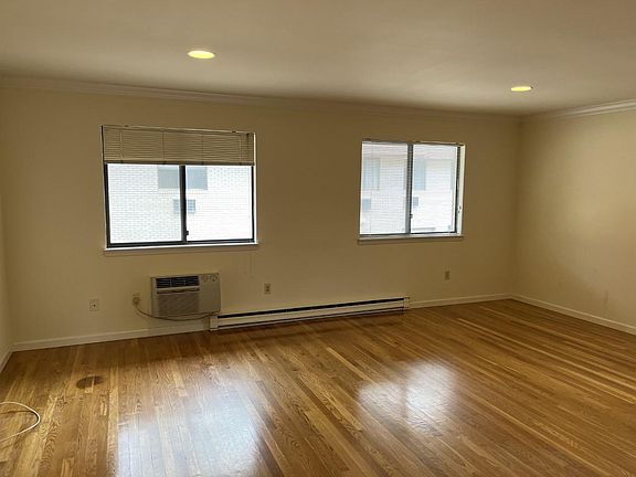 Sunny living room with hardwood floors.
