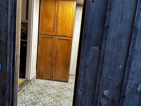Entrance into mud room. Build in cabinets.