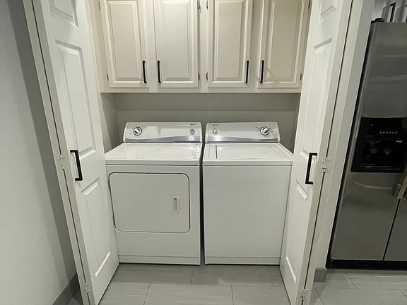In-unit washer and dryer with laundry room storage.