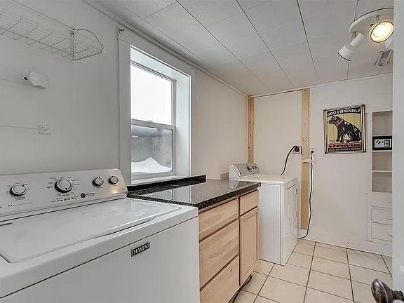 Laundry room with large closet and built-in storage. Additional storage room is not pictured.