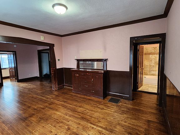 View from dining room into living room (left) and bath (right)
