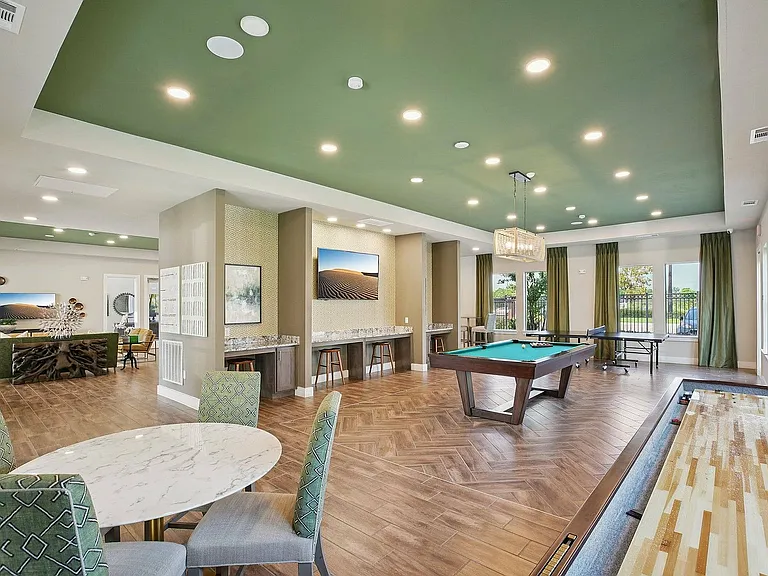 Pool tables and comfortable seating make the Cityscape Apartments billiards room a favorite amenity.