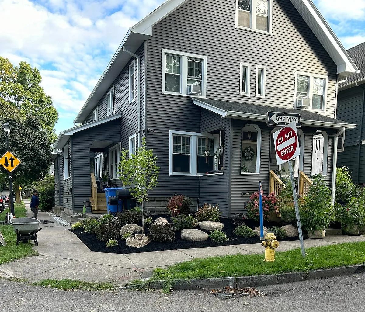 Front corner of building after recent landscaping was completed. Additional landscaping has been installed, including a row of blue perennial flowers between the sidewalk and the building in front of the available unit. - 45 Luzerne St