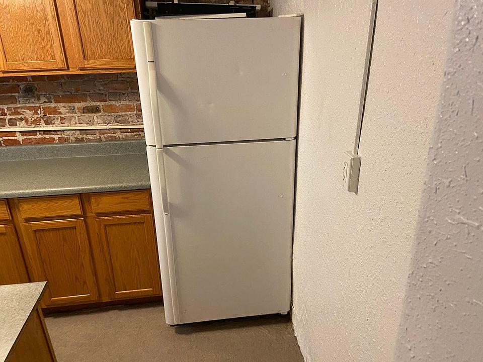 Kitchen looking right to left photo #1. Full size fridge with ice maker!