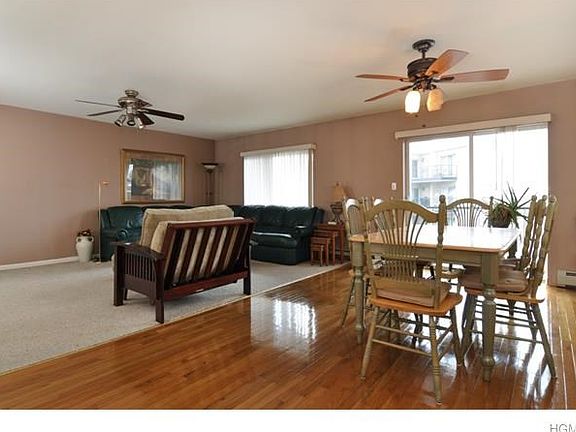 BEAUTIFUL HARDWOOD FLOORING AND DINING AREA WITH SLIDING DOORS AND SUNSET WATER VIEWS