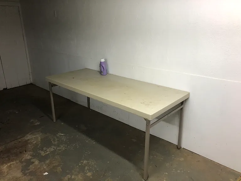 folding table in basement opposite wash and dryer
