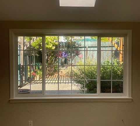Living Room window to backyard cement patio, and skylight