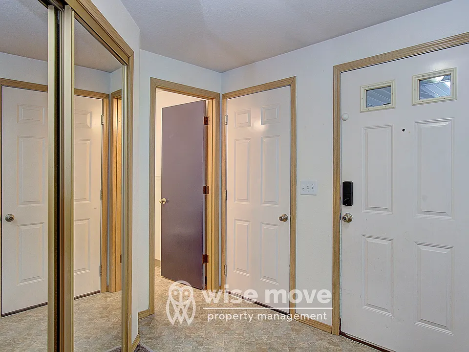 Entry with garage door and front bathroom entrance
