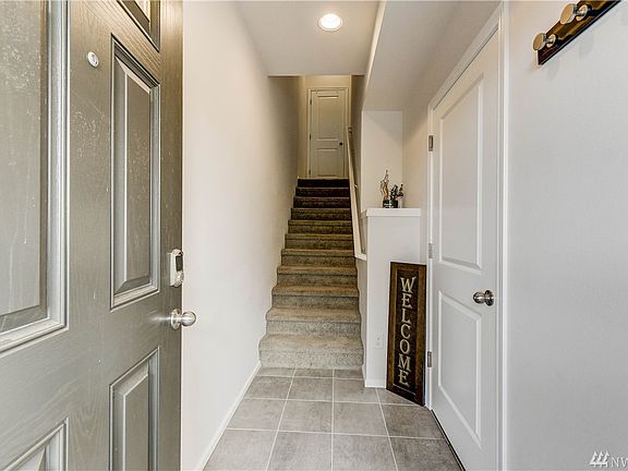 Entry - door to right leads to two car tandem garage with storage nook and fully fenced backyard