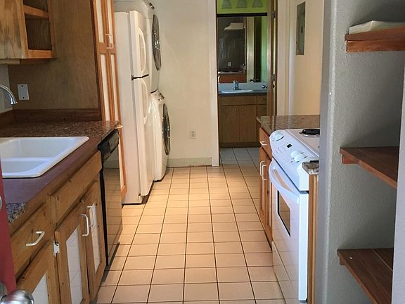 View of the kitchen with a peak into the bathroom.