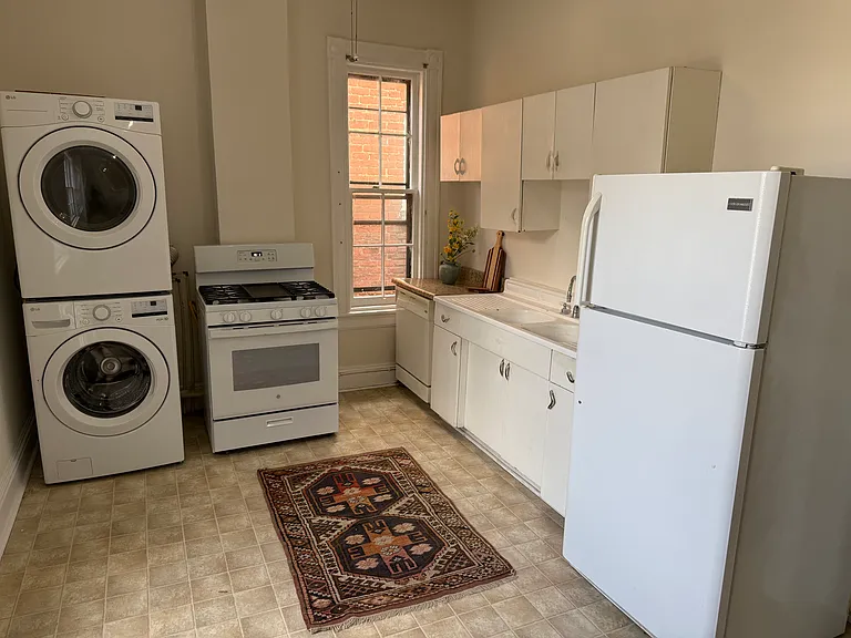Freshly painted kitchen with new washer, dryer and refrigerator.