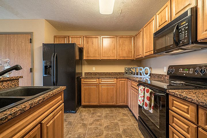 Kitchen with side-by-side refrigerator and abundant cabinet space.