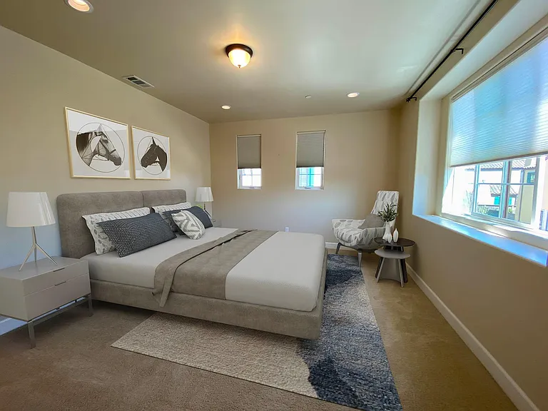 Spacious primary suite with large windows and plenty of room for a sitting area.