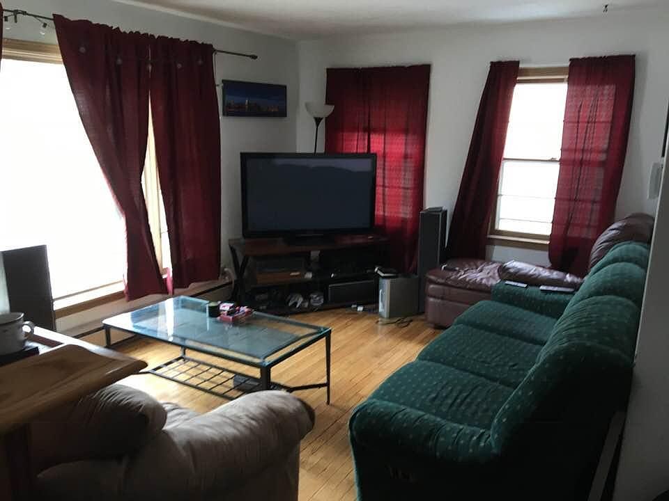Large sunny living room with hardwoods 