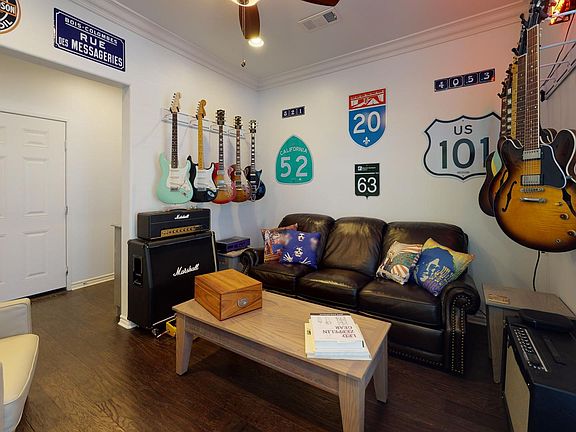 Ground level media/game room with full bathroom and adjacent to outdoor patio.