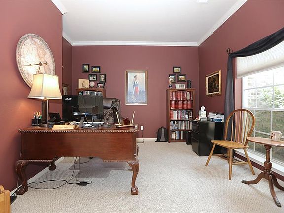 Large study with natural sunlight in the front of the house.