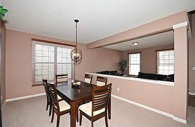Great size Dining room with Wood blinds.  Custome Wood blinds throughout the home.