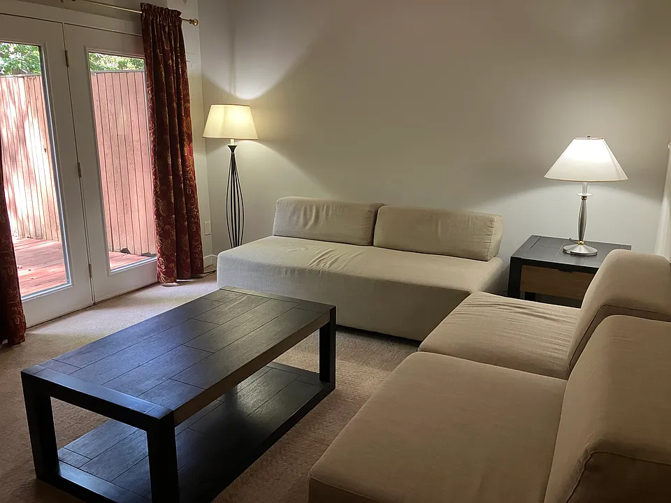 TV room with ample seating and access to back deck