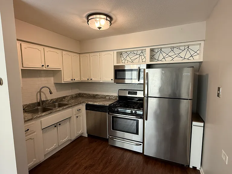 Updated kitchen that includes a gas stove, microwave, and dishwasher