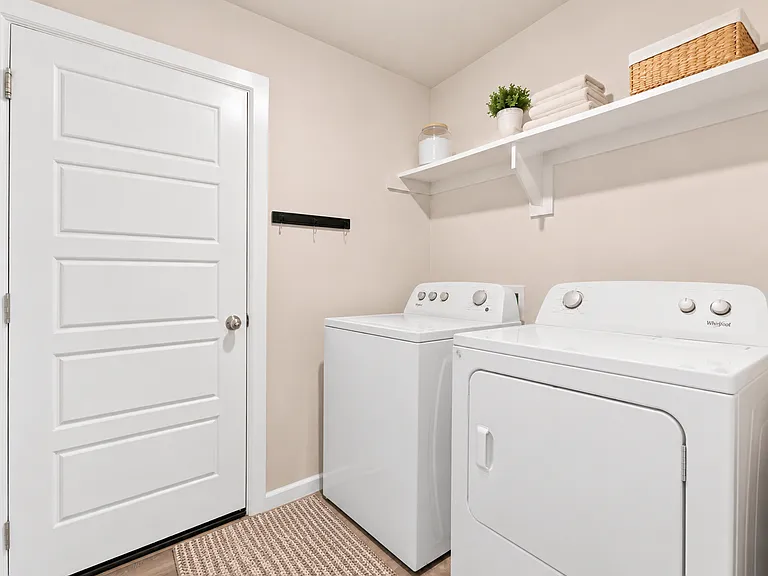 Laundry area leading to two car garage
